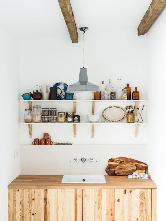 simple ikea shelving with kitchen goods over wood cabinet with sink. / sfgirlbybay