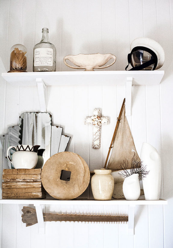 open white shelves with curated vintage decor. / sfgirlbybay