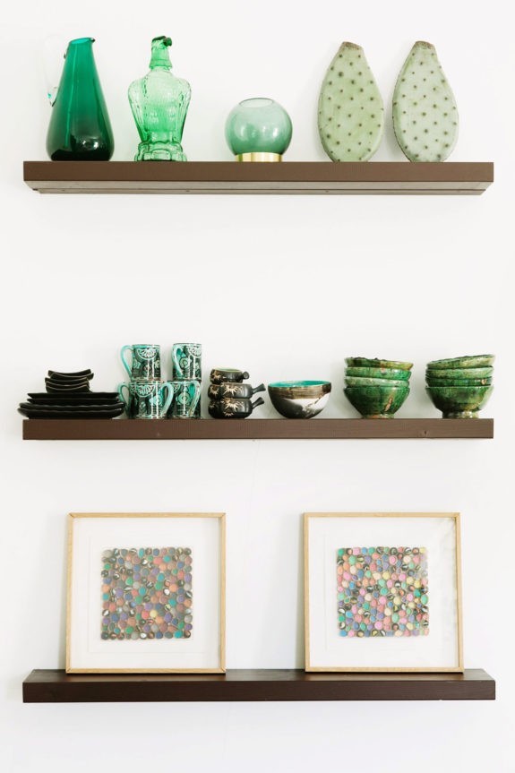 green ceramics, glassware and cactus paddles on simple wood shelves. / sfgirlbybay