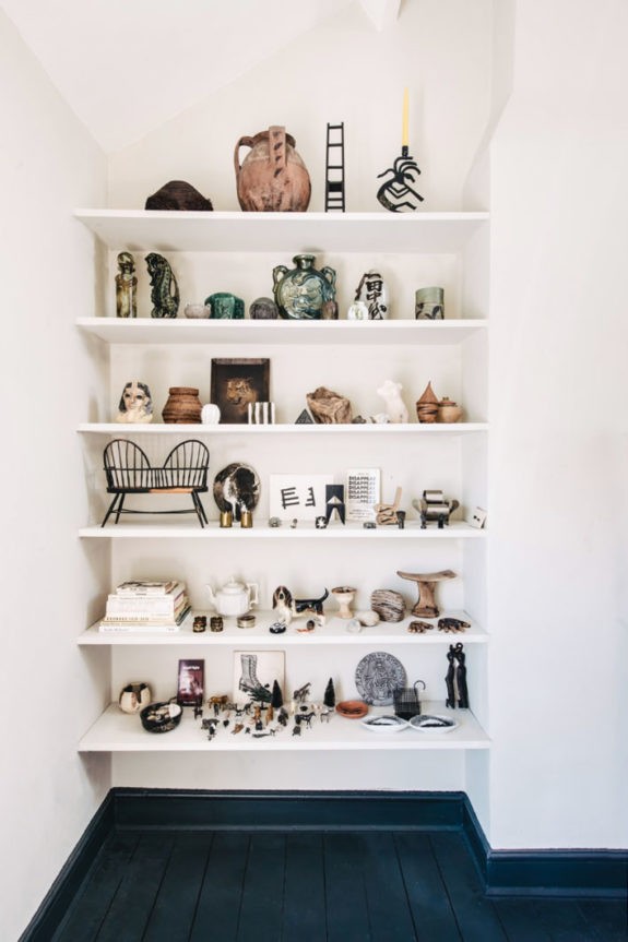 white built-in bookcase styled with art objects. / sfgirlbybay