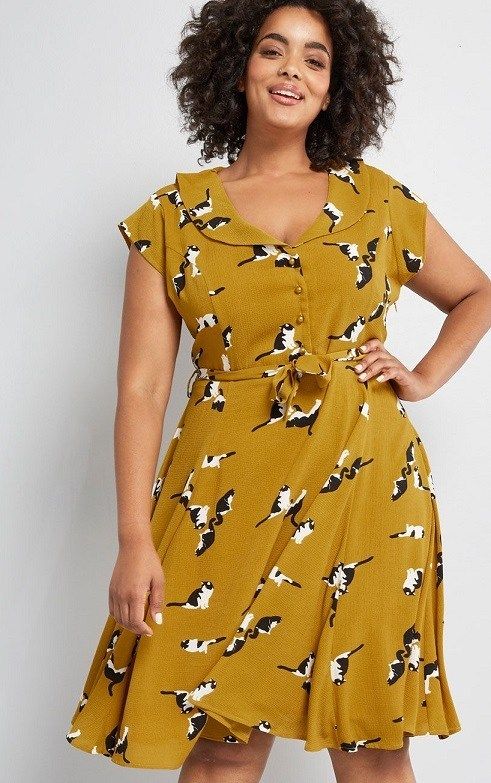 Yellow A-Line Dress Plus Size Cute Cat Print: This mustard yellow dress from Collectif! Given a retro spin this plus size dress, with its sweeping collar, cap sleeves, and pearly-buttoned bodice above a pleated skirt - all of which flaunt a quirky pattern of black and white cats A3 #PlusSizeDresses #getthelook #PlusSize #PlusSizeFashion #PlusSizeStyle #CurvyGirl #boldcurvyfashionista #curvesarein #curvesfordays #curvy #curvyfashionista #Fashion #Style #PlusSizeDresses